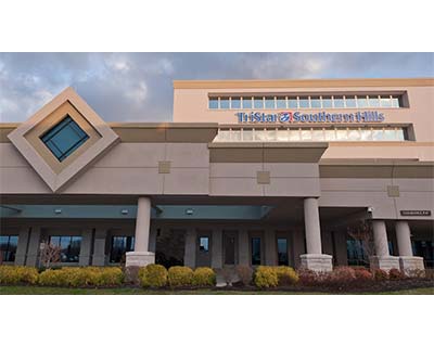 Exterior view of TriStar Southern Hills building with beige columns, geometric architectural features, and landscaping in front.