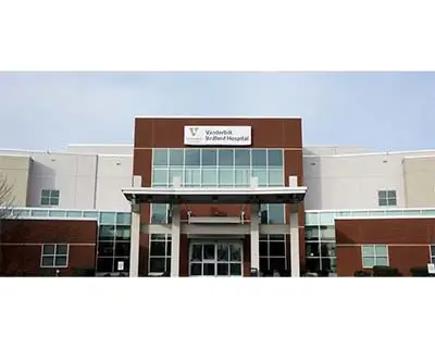 Exterior view of the entrance to Vanderbilt Stallworth Rehabilitation Hospital, showing a modern building with large windows and a visible sign above the entrance.